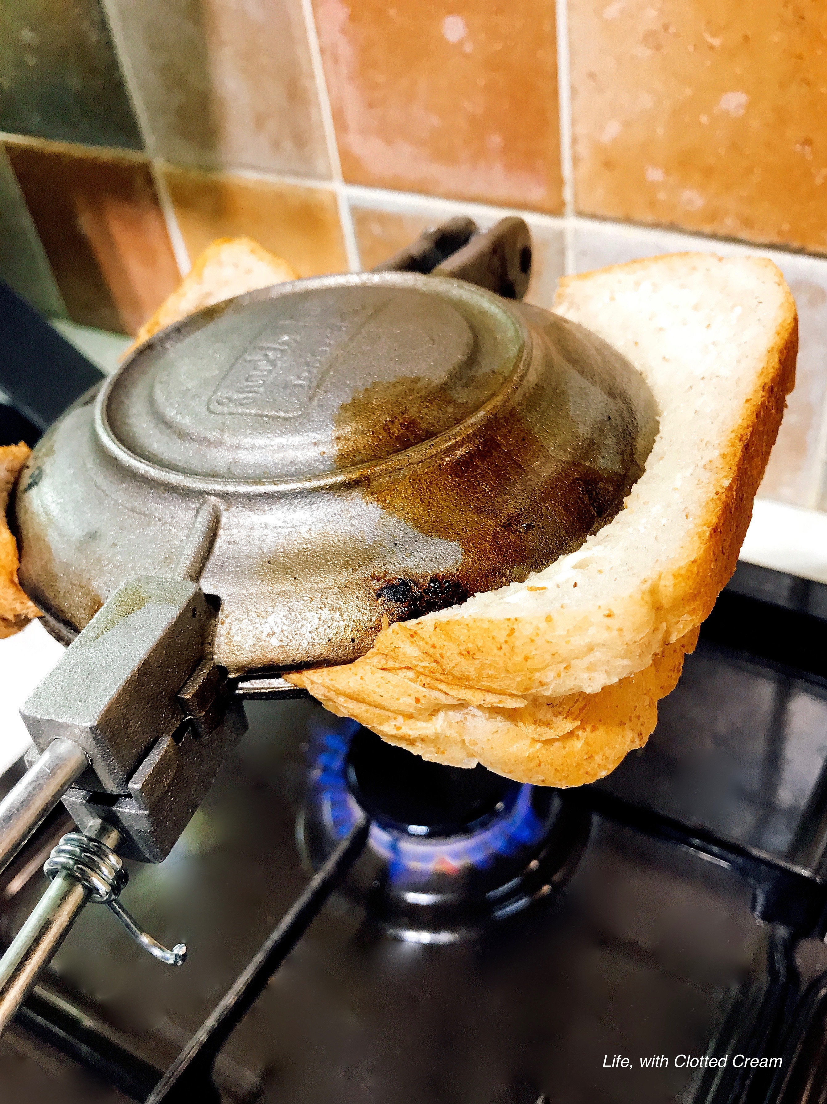 Toasting the jaffle over a naked flame