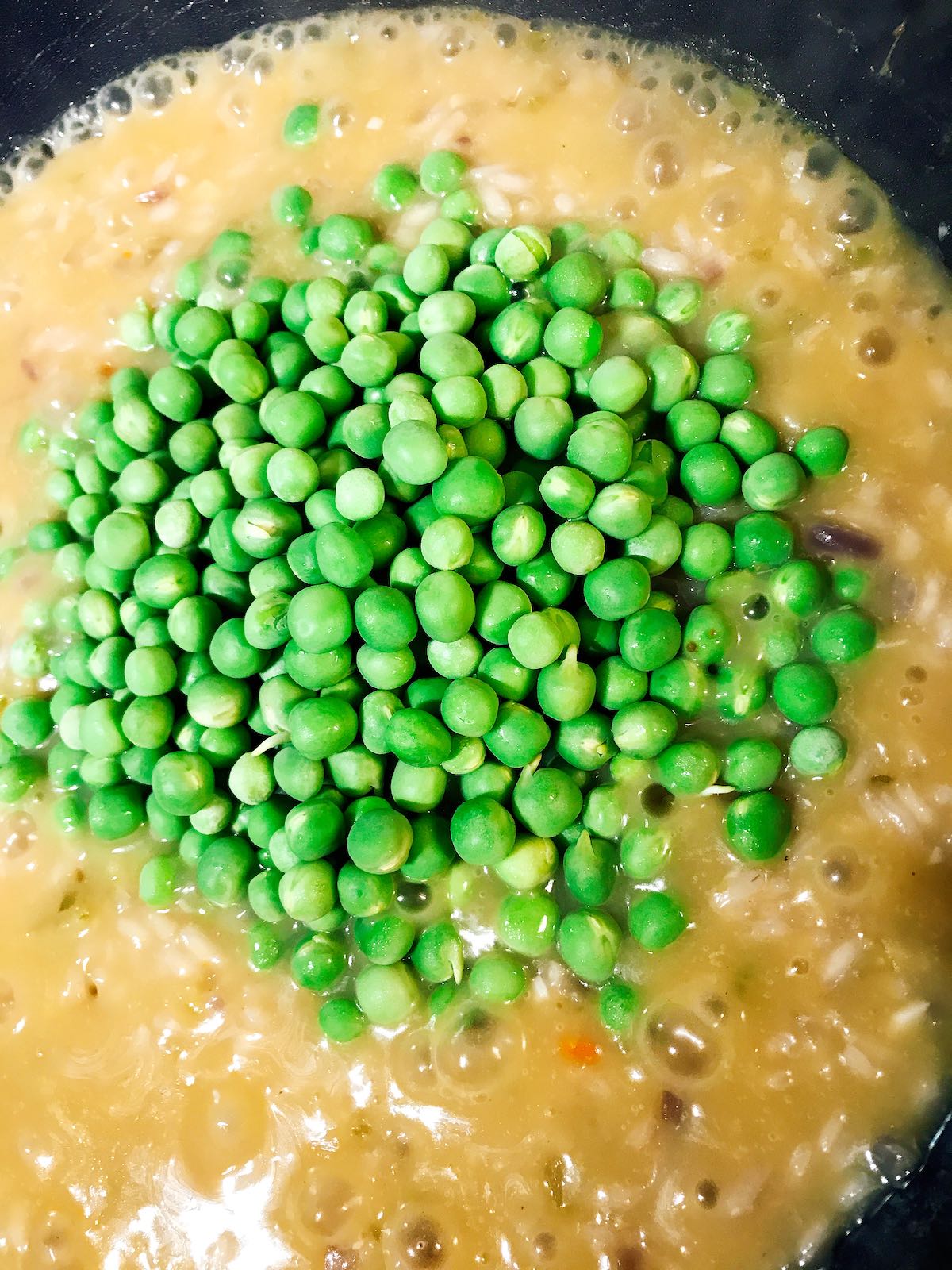Nearly cooked through risotto with fresh peas