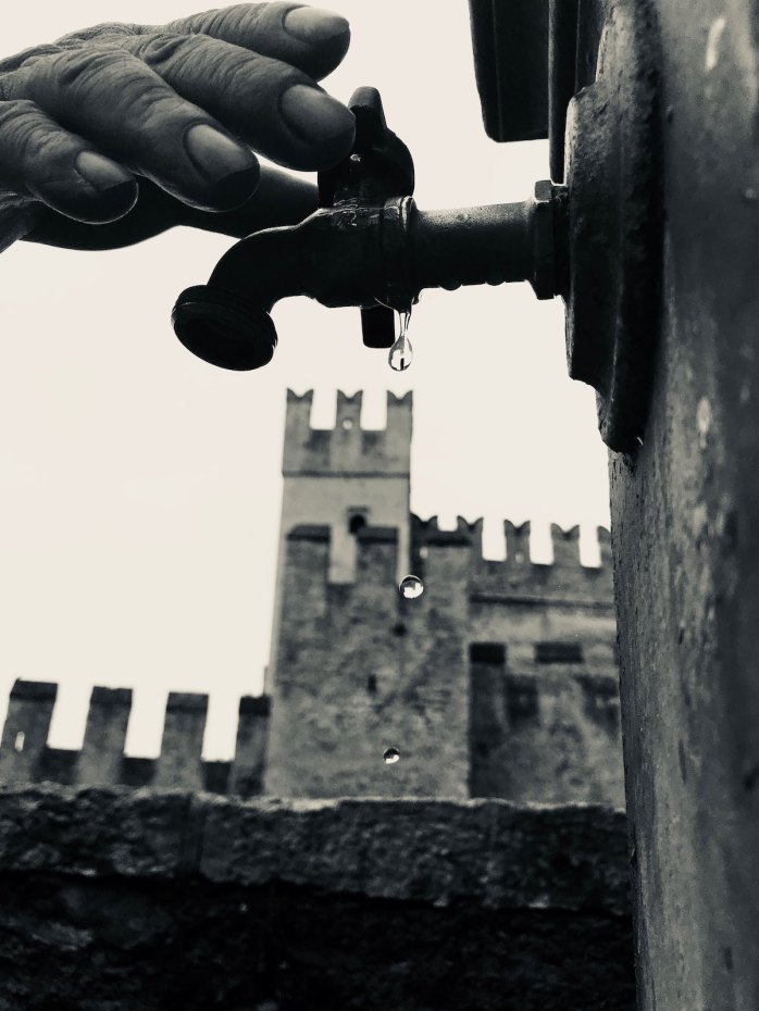 Hand on tap outside Sirmione Castle