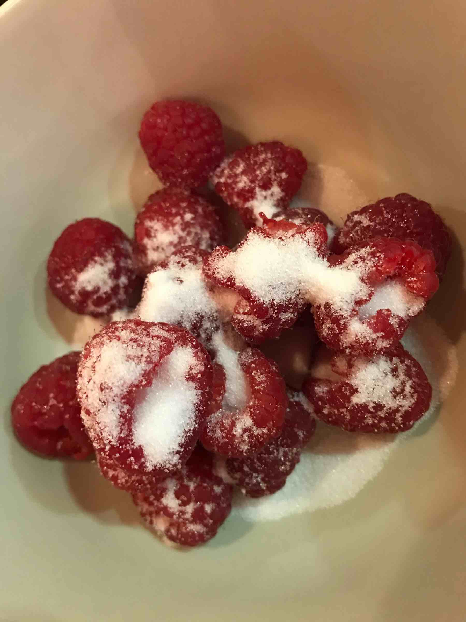 Sugar sprinkled over raspberries