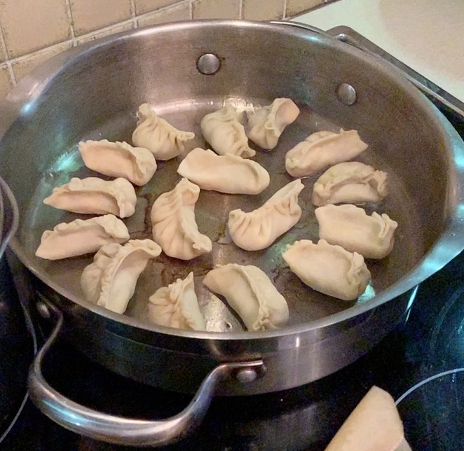 Gyoza being cooked on the stove