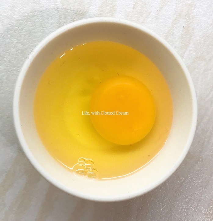 Cracked egg in cup
