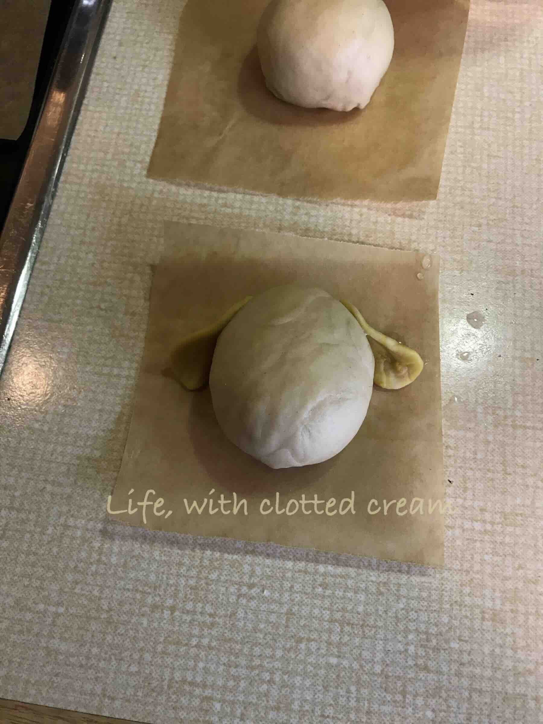 Dog ears attached to a ball of dough.