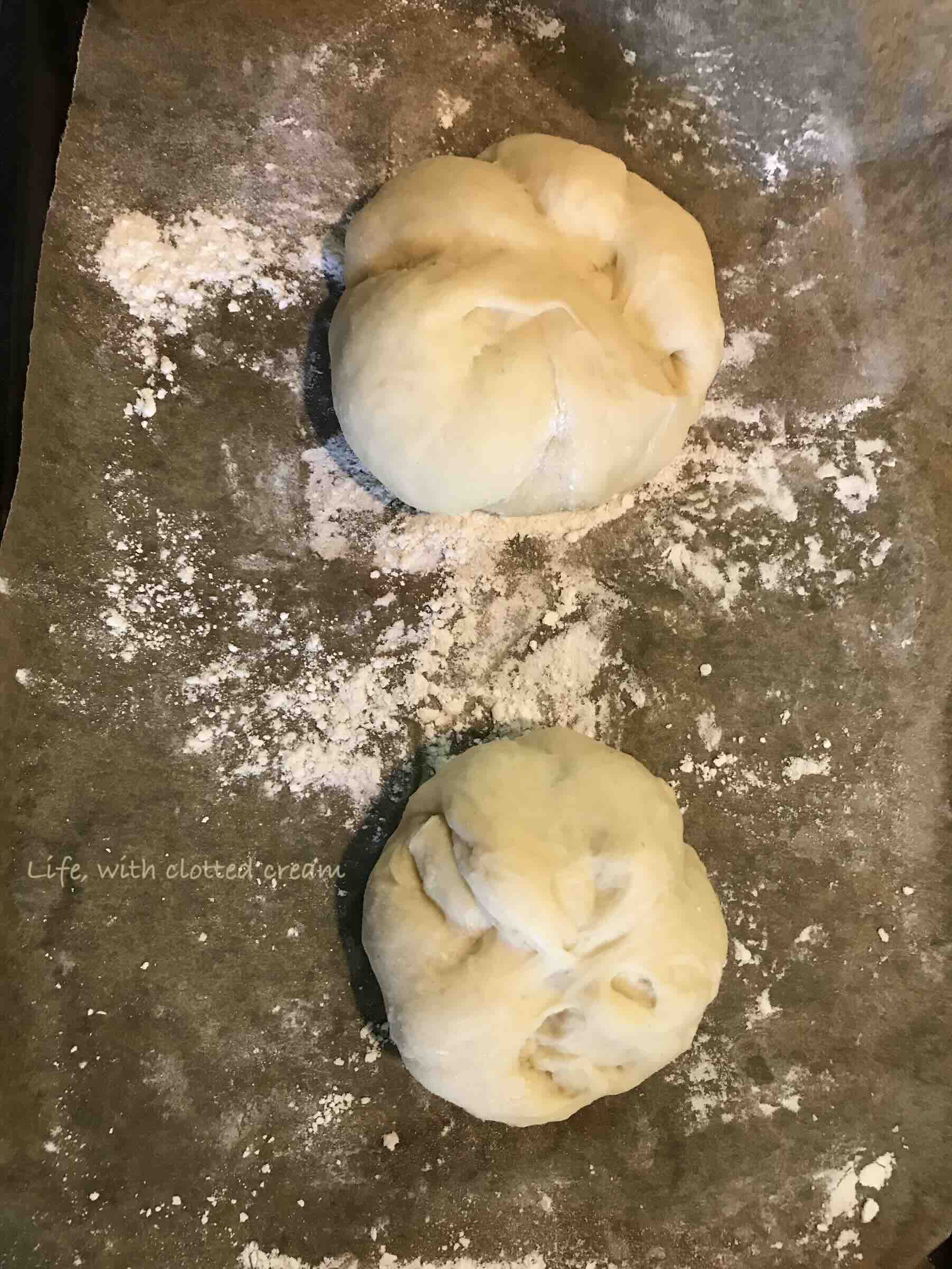 Flipping over a kaiser roll to show the underside after it has been proved.