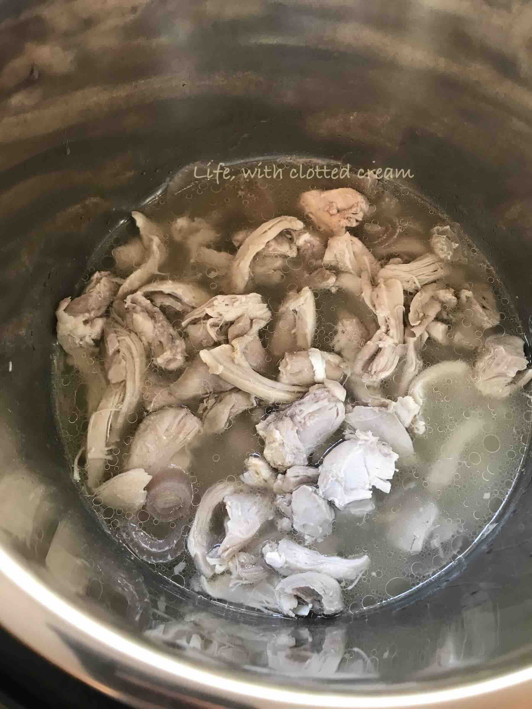 Shredded chicken in stock.