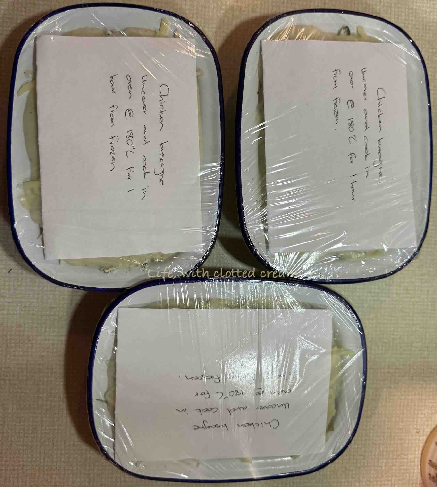Unbaked chicken lasagna wrapped in clingfilm, labelled with cooking instructions.