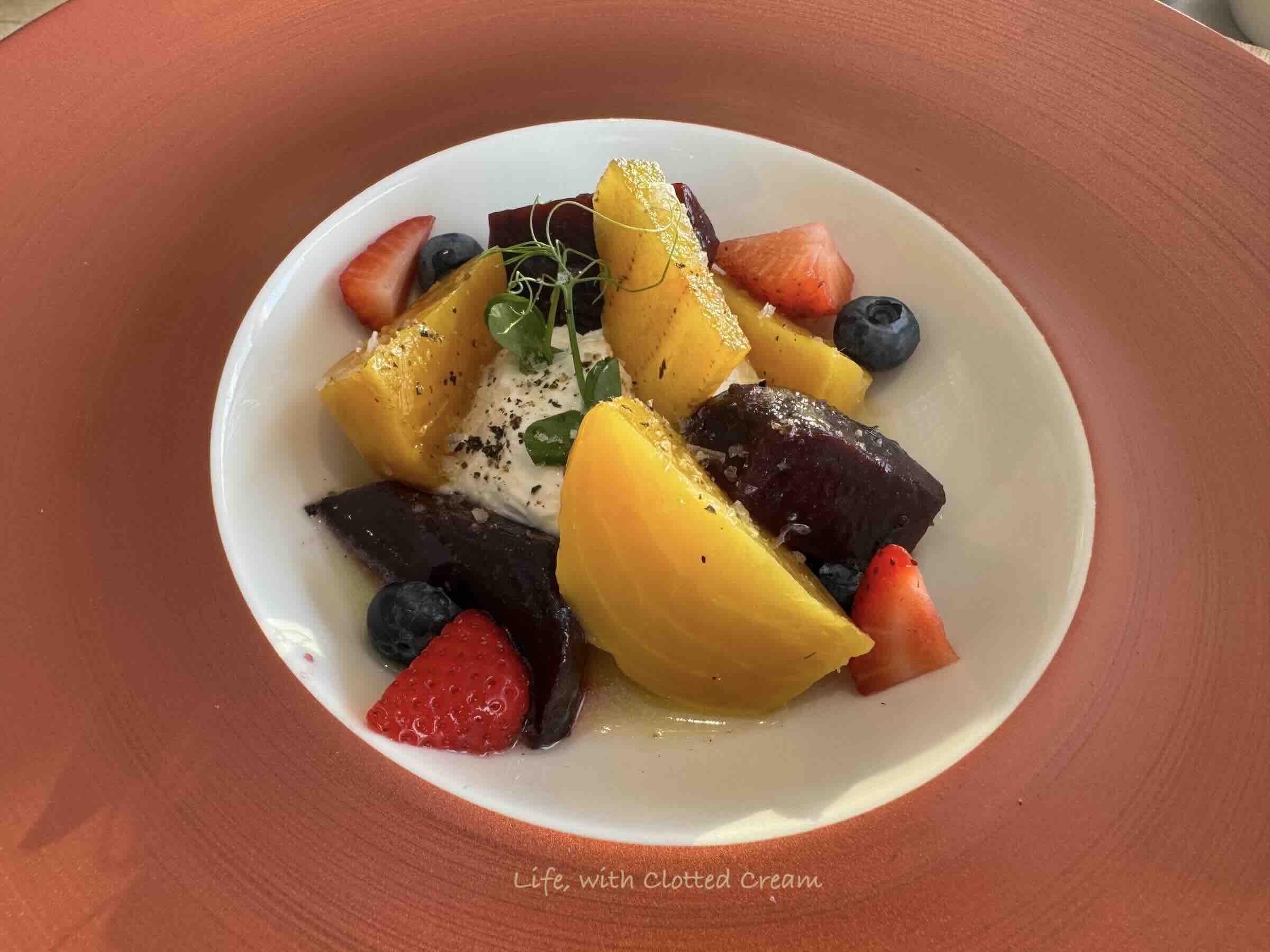 Red and orange beetroot salad with goat's cheese.