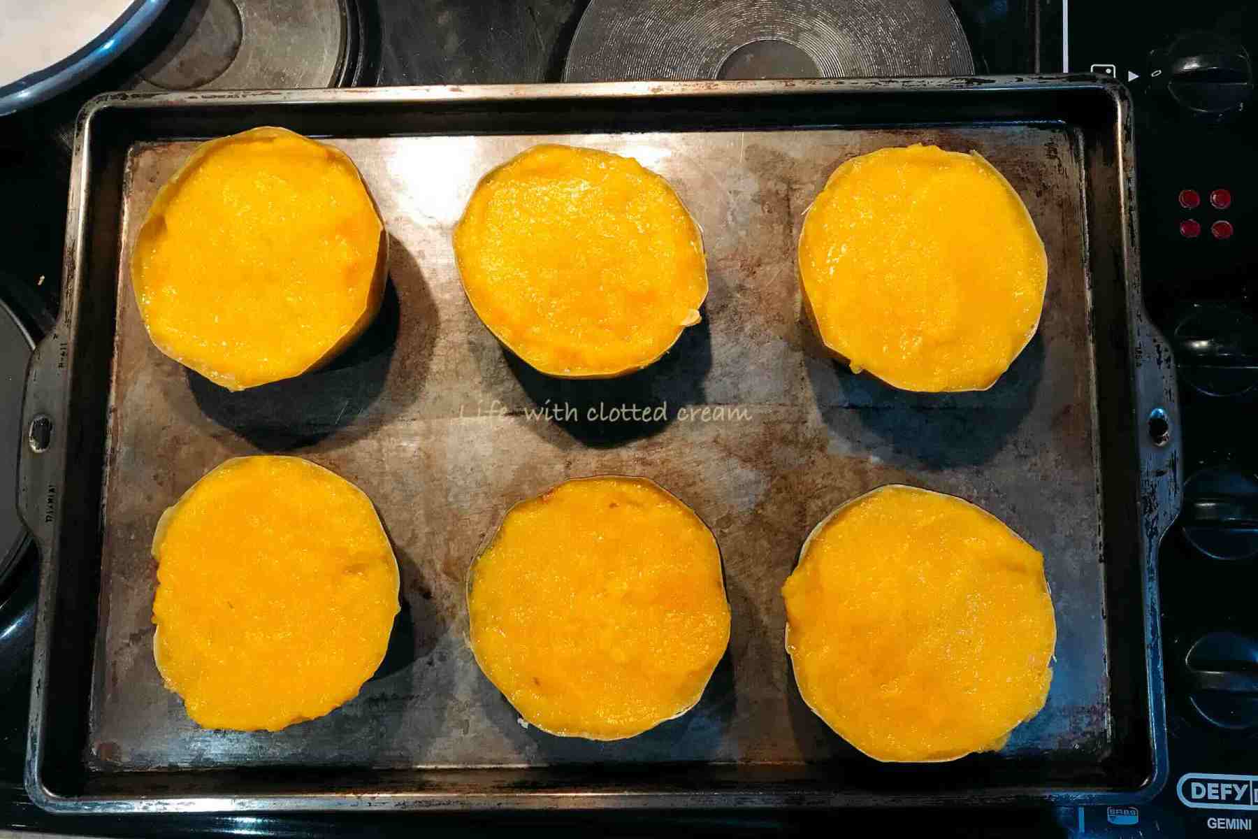 Filled gem squash on a seasoned tray.
