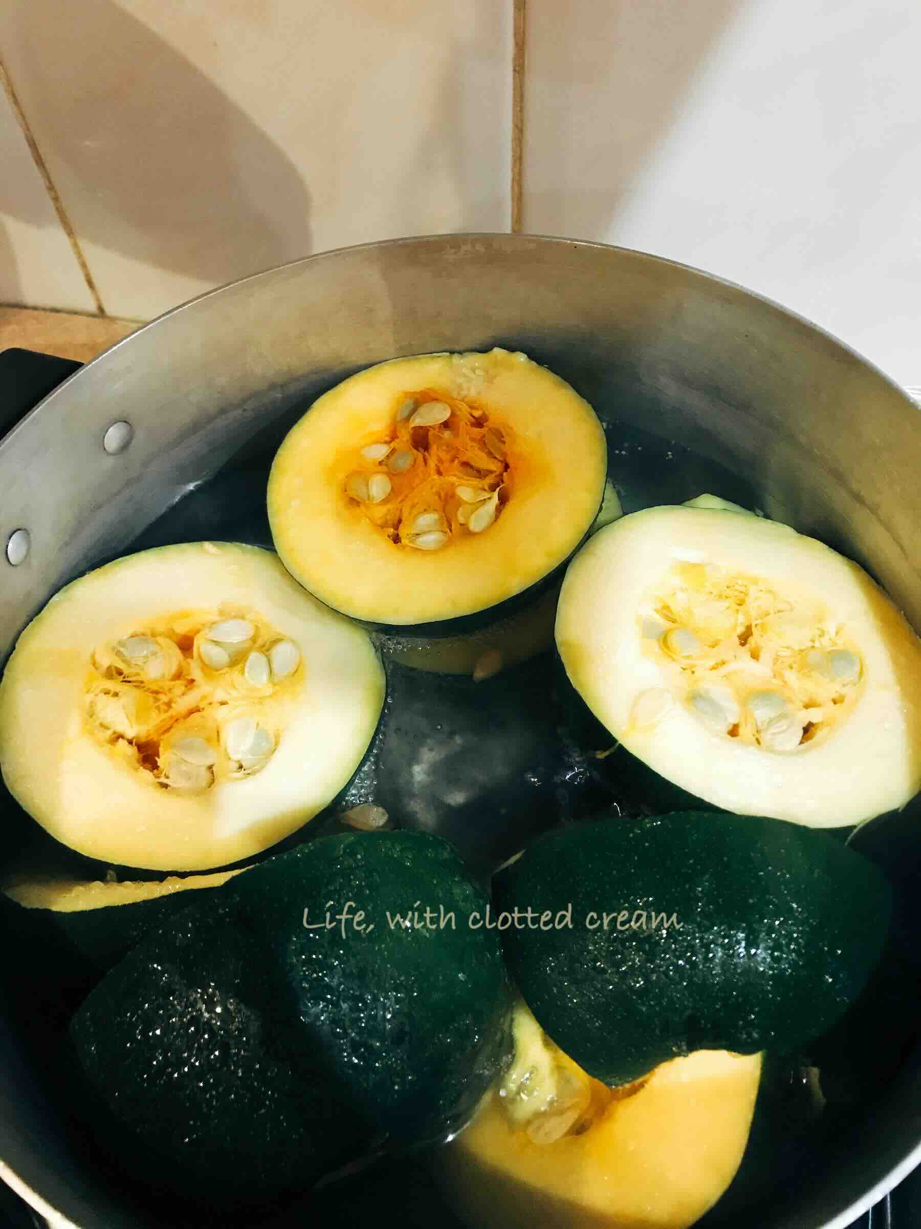 Halved gem squash in a pot with salted water.