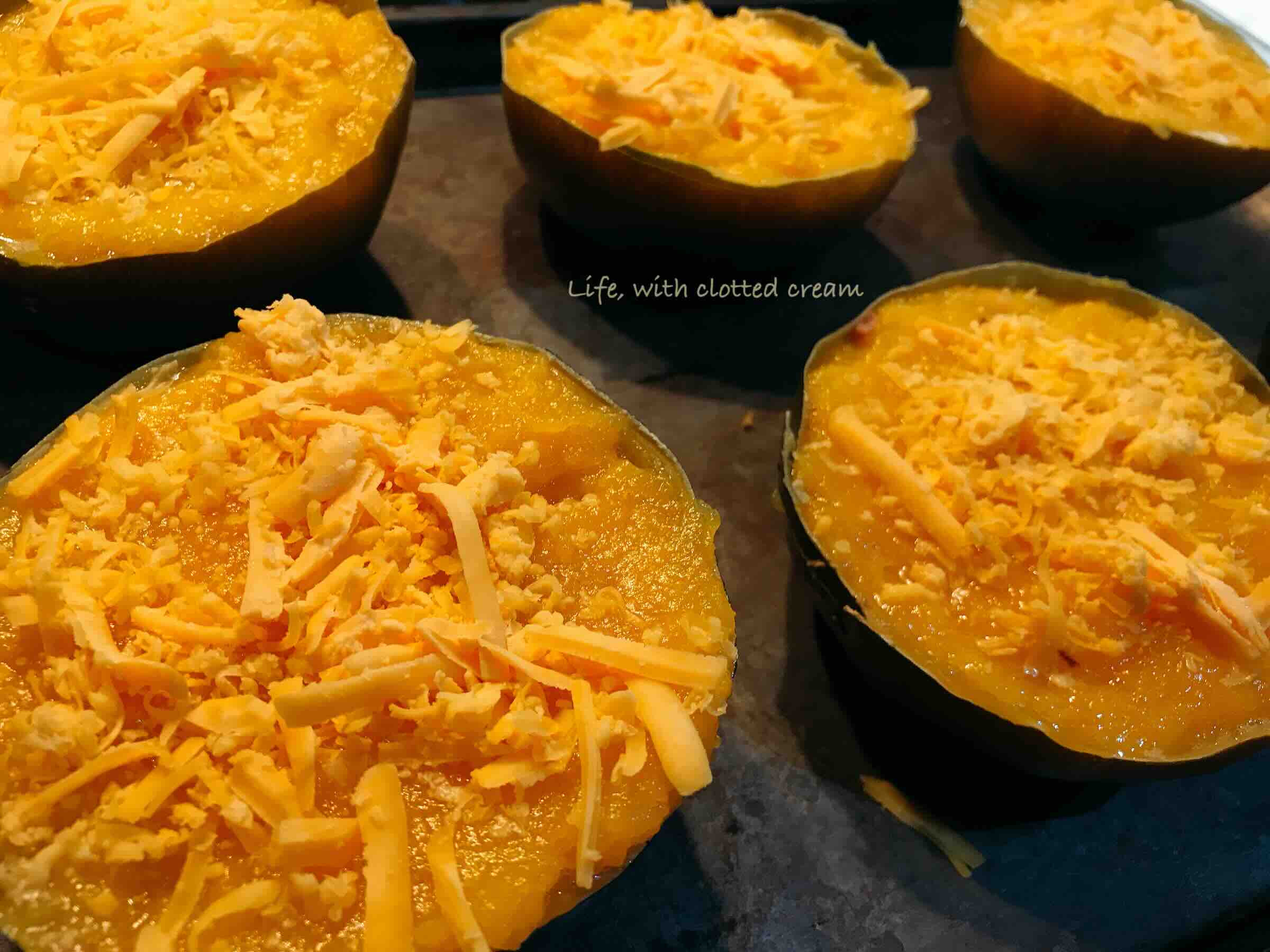 Filled gem squash topped with cheese.