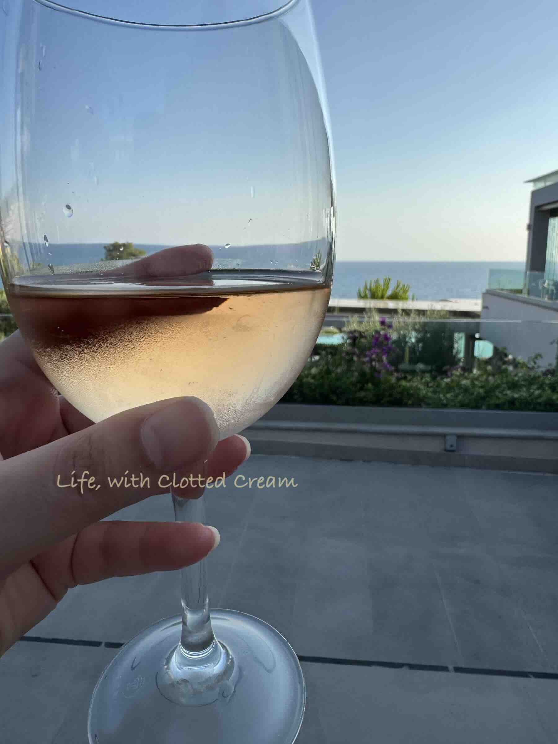 Ocean views from Anaya restaurant at Ikos Oceania in Halkidiki with a glass of rose in hand.